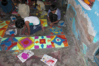 CHILDREN DOING RANGOLI